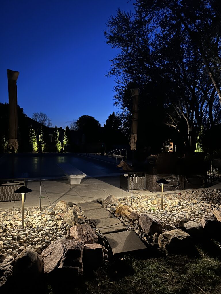 Landscape pathway lighting illuminating walkway at night
